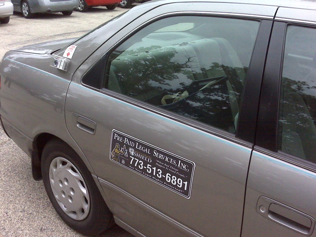 Car with Magnetic Sign on Side Prepaid Legal Services